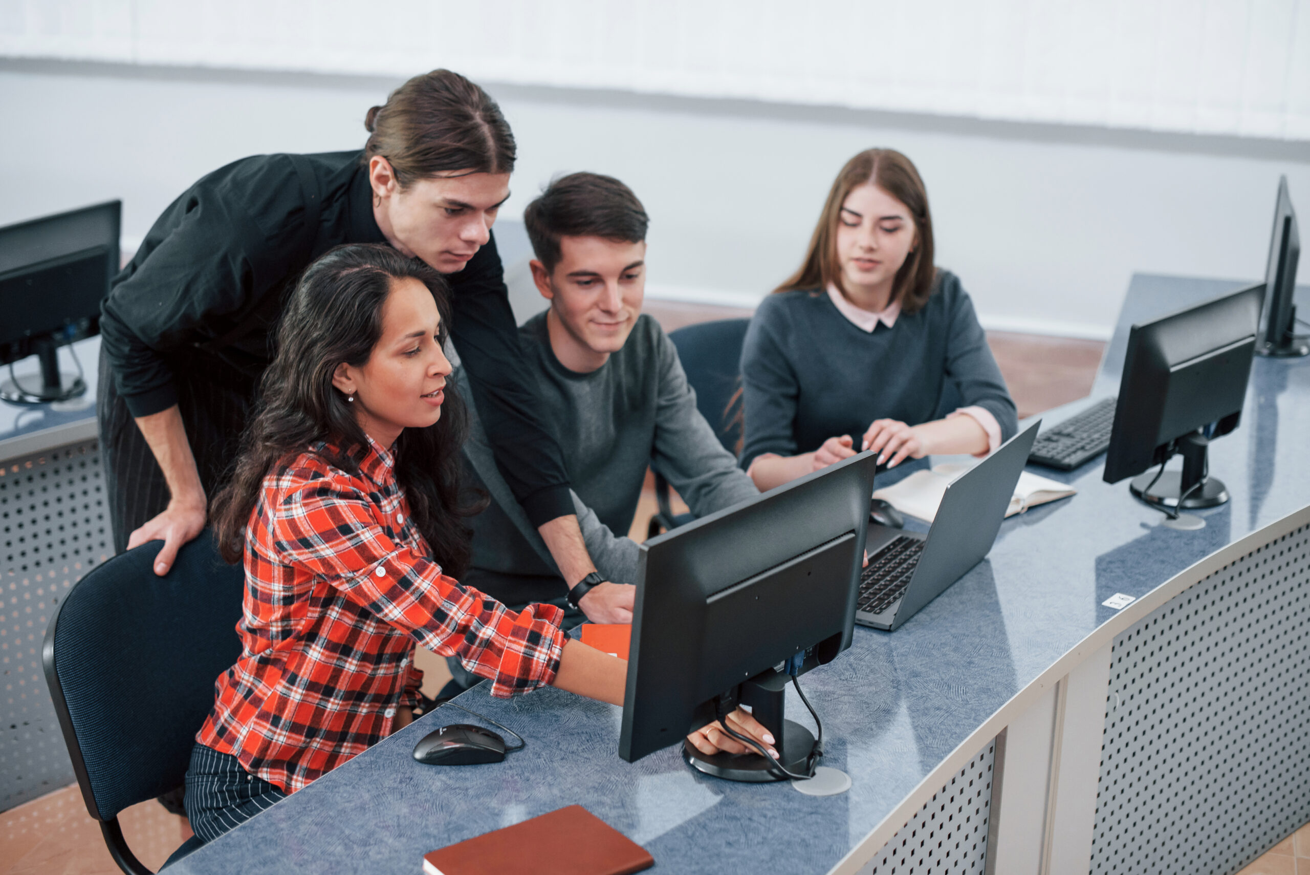 Look at this. Group of young people in casual clothes working in the modern office.